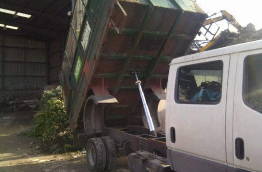 a waste removal truck with garden waste